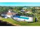 Aerial view of community pool, clubhouse, and surrounding landscape at 500 San Lino Cir # 511, Venice, FL 34292