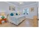 King-size bed, coastal decor, and ceiling fan at 500 San Lino Cir # 511, Venice, FL 34292