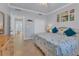 King-size bed, coastal decor, and access to bathroom at 500 San Lino Cir # 511, Venice, FL 34292