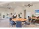Bright clubhouse room featuring tables, chairs, ceiling fans, and a view of the pool area at 500 San Lino Cir # 511, Venice, FL 34292