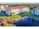 Beautiful condominium complex featuring a lake with a gazebo, lush landscaping and well-maintained exterior at 500 San Lino Cir # 511, Venice, FL 34292