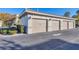 Three-car garage with beige doors and landscaping at 500 San Lino Cir # 511, Venice, FL 34292