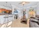 Bright living room features a comfy leather couch, a large TV, and a kitchen with granite countertops at 500 San Lino Cir # 511, Venice, FL 34292