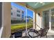 Screened porch with wicker furniture and view of the water at 500 San Lino Cir # 511, Venice, FL 34292