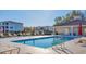Outdoor swimming pool with plenty of lounge chairs in a well-maintained community with condo buildings at 500 San Lino Cir # 511, Venice, FL 34292