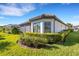 House exterior with well-maintained hedges and lawn at 5397 Bartolomeo St, Sarasota, FL 34238