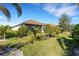View of the home's back and beautifully landscaped yard at 5397 Bartolomeo St, Sarasota, FL 34238
