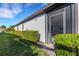 House exterior showcasing a well-manicured lawn and hedgerows at 5397 Bartolomeo St, Sarasota, FL 34238