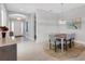 Dining room with wood table, six chairs, and light gray walls at 5397 Bartolomeo St, Sarasota, FL 34238