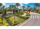 Beautifully landscaped community entrance with stone signage and vibrant flowerbeds at 5397 Bartolomeo St, Sarasota, FL 34238