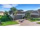 One-story home with tile roof, palm trees, and a two-car garage at 5397 Bartolomeo St, Sarasota, FL 34238