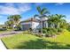 Single-story home with tile roof, landscaped yard, and two-car garage at 5397 Bartolomeo St, Sarasota, FL 34238
