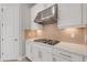 Kitchen detail showcasing gas cooktop and hexagon backsplash at 5397 Bartolomeo St, Sarasota, FL 34238