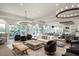 Spacious living room featuring elegant chandeliers, comfortable seating, and abundant natural light at 5397 Bartolomeo St, Sarasota, FL 34238