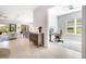 Home office with large window, desk, and chair, open to living area at 5397 Bartolomeo St, Sarasota, FL 34238
