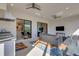 Relaxing outdoor space with seating, a TV, and access to the kitchen at 5397 Bartolomeo St, Sarasota, FL 34238