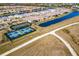 Aerial view of community with tennis and pickleball courts, and lakes at 6226 Plateau Ct, Bradenton, FL 34203