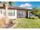 Landscaped backyard with grassy area and screened porch at 6226 Plateau Ct, Bradenton, FL 34203