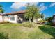Landscaped backyard with grassy area and screened porch at 6226 Plateau Ct, Bradenton, FL 34203