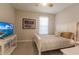Bright bedroom with a queen-size bed and TV at 6226 Plateau Ct, Bradenton, FL 34203