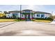 Community clubhouse with modern design, landscaping, and plenty of parking at 6226 Plateau Ct, Bradenton, FL 34203
