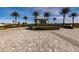 Gated community entrance with palm trees and landscaping at 6226 Plateau Ct, Bradenton, FL 34203