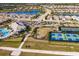 Aerial view of community with homes, lake, and recreational amenities at 6226 Plateau Ct, Bradenton, FL 34203