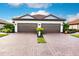 Two-car garage, paver driveway, and nicely landscaped yard at 6226 Plateau Ct, Bradenton, FL 34203