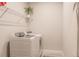 Bright laundry room with washer, dryer, and shelving at 6226 Plateau Ct, Bradenton, FL 34203