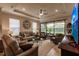 Relaxing living room featuring ample seating and a large TV at 6226 Plateau Ct, Bradenton, FL 34203