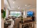 Spacious living room with large TV, comfortable sofas, and high ceilings at 6226 Plateau Ct, Bradenton, FL 34203
