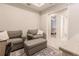 Cozy sitting room with two armchairs, ottoman, and view of bedroom at 6226 Plateau Ct, Bradenton, FL 34203