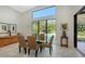 Modern dining room with glass table and pool view at 653 40Th St, Sarasota, FL 34234