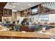Clubhouse bar area with bar seating, TVs, and golf course views at 6640 Pineview Ter # 6640, Bradenton, FL 34203