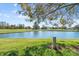 Scenic golf course view with pond and trees at 6640 Pineview Ter, Bradenton, FL 34203