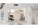 View of kitchen with white cabinets, granite counters, and stainless steel appliances at 6640 Pineview Ter # 6640, Bradenton, FL 34203
