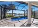 Inviting pool area with waterfall feature and lake view at 6750 Alstead Cir, Lakewood Ranch, FL 34202