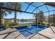 Screened-in pool and spa with a waterfall feature and lake view at 6750 Alstead Cir, Lakewood Ranch, FL 34202