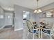 Bright dining room with glass table and wicker chairs, open to kitchen at 676 Park Cir, Bradenton, FL 34207