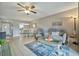 Living room with comfy seating, coffee table, and ceiling fan at 676 Park Cir, Bradenton, FL 34207