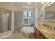 Bathroom features a soaking tub, walk-in shower, and granite countertops at 7041 Beechmont Ter, Lakewood Ranch, FL 34202