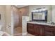 Bathroom with walk-in shower, granite vanity, and large mirror at 7041 Beechmont Ter, Lakewood Ranch, FL 34202