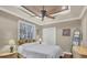Guest bedroom with hardwood floors and ceiling fan at 7041 Beechmont Ter, Lakewood Ranch, FL 34202