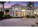 Inviting home exterior featuring a circular driveway and manicured landscaping at 7041 Beechmont Ter, Lakewood Ranch, FL 34202