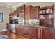 Game room with wet bar, hardwood floors, and built-in shelving at 7041 Beechmont Ter, Lakewood Ranch, FL 34202
