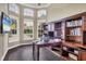 Spacious home office with built-in bookcases and large windows at 7041 Beechmont Ter, Lakewood Ranch, FL 34202