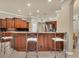 Kitchen boasts a breakfast bar with seating and rich wood cabinetry at 7041 Beechmont Ter, Lakewood Ranch, FL 34202
