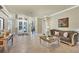 Comfortable living room with a sofa, coffee table, and access to the backyard at 7041 Beechmont Ter, Lakewood Ranch, FL 34202