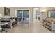 Relaxing living area featuring a stylish sofa and views of the pool area at 7041 Beechmont Ter, Lakewood Ranch, FL 34202
