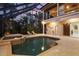 Night view of the pool and spa with screened enclosure at 7041 Beechmont Ter, Lakewood Ranch, FL 34202
